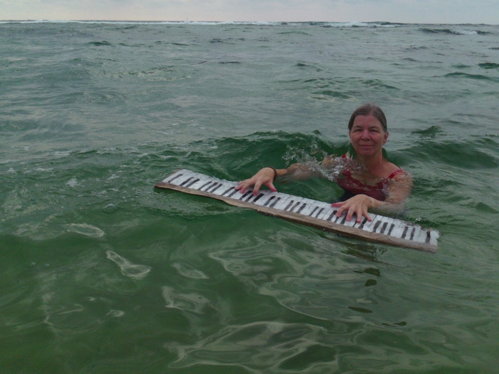 Helen in the Indian Ocean with a driftwood keyboard made by Lorna Rees